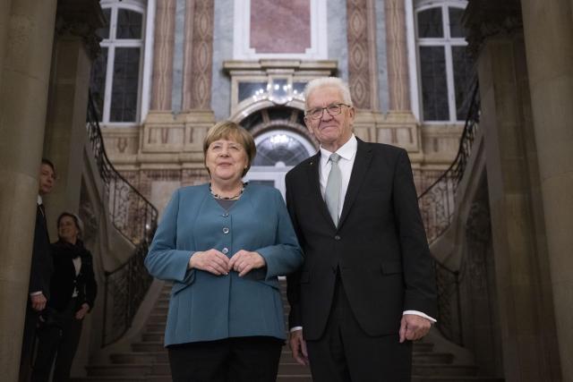 09 December 2025, Baden-Wuerttemberg, Stuttgart: Minister President of Baden-Wuerttemberg Winfried Kretschmann (R) posess with former German Chancellor Angela Merkel in the Marble Hall of the New Palace. Merkel receives the Staufer Medal in Gold for her coronavirus policy. Photo: Marijan Murat/dpa