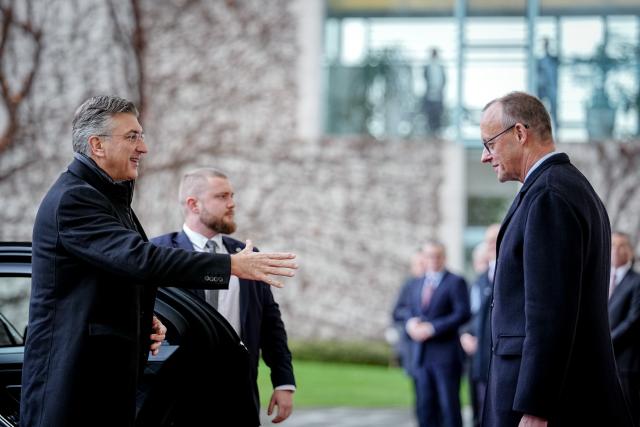 10 December 2025, Berlin: German Chancellor Friedrich Merz (R) welcomes the Prime Minister of the Republic of Croatia, Andrej Plenkovic, with military honors in front of the Federal Chancellery. Photo: Kay Nietfeld/dpa