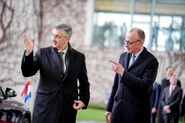 10 December 2025, Berlin: German Chancellor Friedrich Merz (r) welcomes the Prime Minister of the Republic of Croatia, Andrej Plenkovic, with military honors in front of the Federal Chancellery. Photo: Kay Nietfeld/dpa