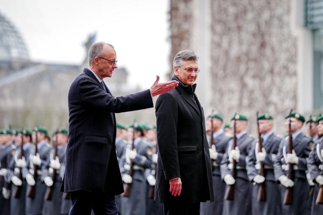 10 December 2025, Berlin: German Chancellor Friedrich Merz (L) welcomes the Prime Minister of the Republic of Croatia, Andrej Plenkovic, with military honors in front of the Federal Chancellery. Photo: Kay Nietfeld/dpa