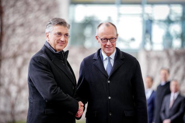 10 December 2025, Berlin: German Chancellor Friedrich Merz (R) welcomes the Prime Minister of the Republic of Croatia, Andrej Plenkovic, with military honors in front of the Federal Chancellery. Photo: Kay Nietfeld/dpa