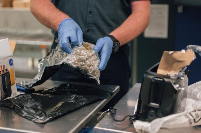FILED - 21 October 2022, North Rhine-Westphalia, Cologne: Jens Ahland, press officer of the customs, holds a toaster in his hands, in which a bag with marijuana was hidden. While Santa may - in one way or another - be currently responsible for a fair share of the 12 million packages entering the EU daily, the bloc is looking to streamline national customs processes, with several cities across the bloc bidding to host a new customs hub. Photo: Marius Becker/Deutsche Presse-Agentur GmbH/dpa