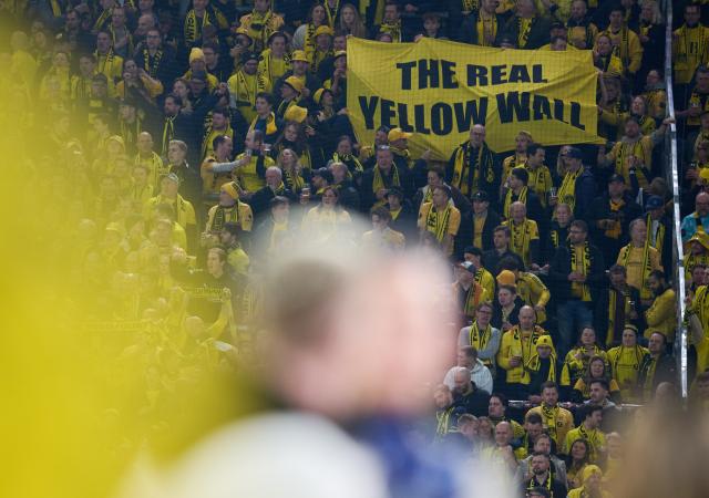 10 December 2025, North Rhine-Westphalia, Dortmund: "The Real Yellow Wall" is written on a banner in the stands prior to the start of the UEFA Champions League soccer match between Borussia Dortmund and FK Bodoe/Glimt at Signal Iduna Park. Photo: Bernd Thissen/dpa