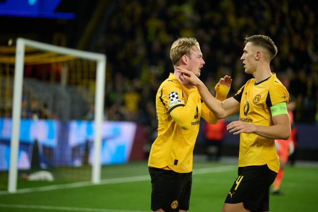 10 December 2025, North Rhine-Westphalia, Dortmund: Borussia Dortmund's Julian Brandt (L) celebrates scoring his side's first goal with teammate Nico Schlotterbeck during the UEFA Champions League soccer match between Borussia Dortmund and FK Bodoe/Glimt at Signal Iduna Park. Photo: Bernd Thissen/dpa