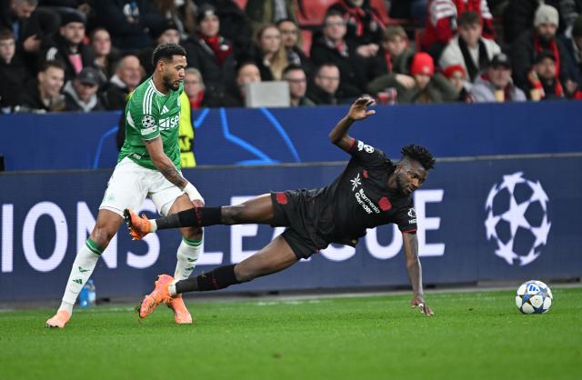 10 December 2025, North Rhine-Westphalia, Leverkusen: Leverkusen's Edmond Tapsoba (R) and Newcastle United's Joelinton battle for the ball during the UEFA Champions League soccer match between Bayer Leverkusen and Newcastle United at BayArena. Photo: Federico Gambarini/dpa