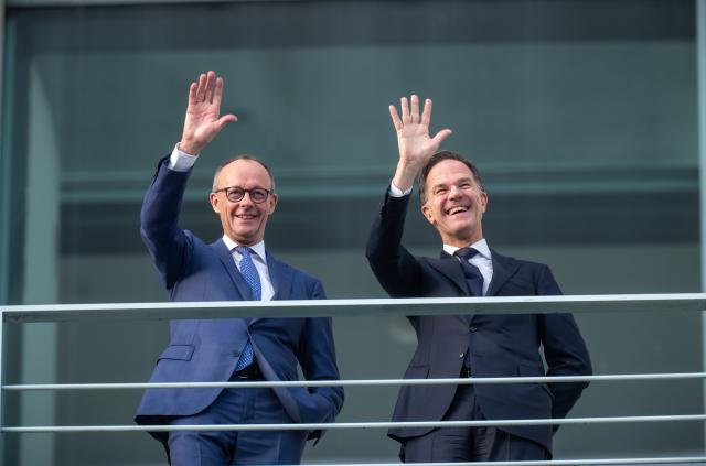 11 December 2025, Berlin: German Chancellor Friedrich Merz (L) waves next to Mark Rutte, NATO Secretary General, before a bilateral meeting at the Federal Chancellery. Photo: Michael Kappeler/dpa