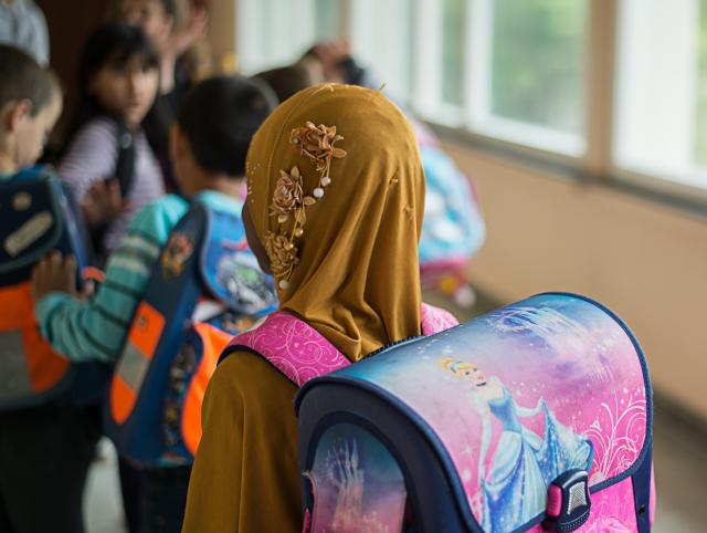 FILED - 19 June 2015, Baden-Württemberg, Stuttgart: A girl wearing a headscarf is pictured in the Rosensteinschule school in Stuttgart. Muslim girls under the age of 14 will no longer be allowed to wear headscarves in Austrian schools, according to an amendment to the law passed on Thursday. Photo: picture alliance / dpa