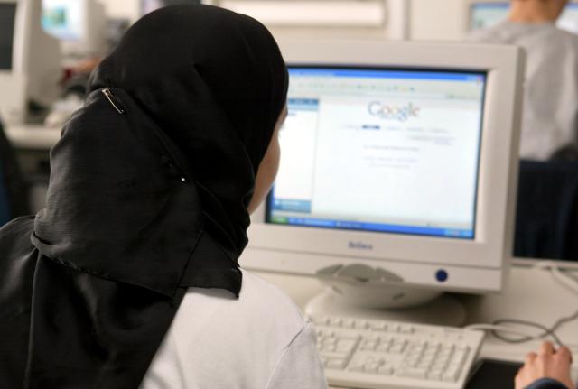 FILED - 11 March 2004, Hessen, Dietzenbach: A student wearing a headscarf attends a computing lesson at a school in Dietzenbach. Muslim girls under the age of 14 will no longer be allowed to wear headscarves in Austrian schools, according to an amendment to the law passed on Thursday. Photo: Frank May/dpa
