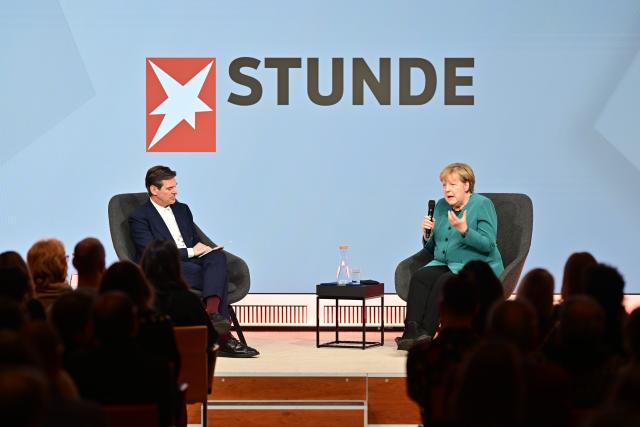 11 December 2025, Berlin: Gregor Peter Schmitz, editor-in-chief of Stern, and former German Chancellor Angela Merkel speak during the "Stern Stunde" talk at the Bertelsmann Representative Office. Photo: Sebastian Christoph Gollnow/dpa