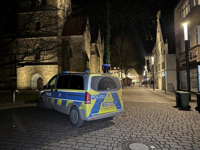 11 December 2025, Herford: A police car is parked near the Christmas market in Herford, where a 16-year-old boy has been critically injured in a knife attack. The incident took place in a side street on the edge of the Christmas market, according to a police spokesman. Photo: Christian Müller/dpa