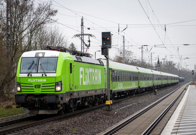 FILED - 22 March 2024, Brandenburg, Trebbin: A Flixtrain passes Trebbin station. Photo: Soeren Stache/dpa
