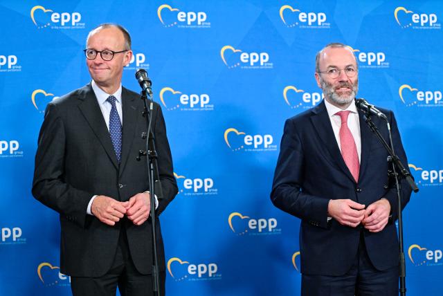 12 December 2025, Baden-Württemberg, Heidelberg: German Chancellor Friedrich Merz (L), and Manfred Weber, party and group leader of the European People's Party, give a press conference at the end of a meeting of the EPP group in the European Parliament. Photo: Uwe Anspach/dpa
