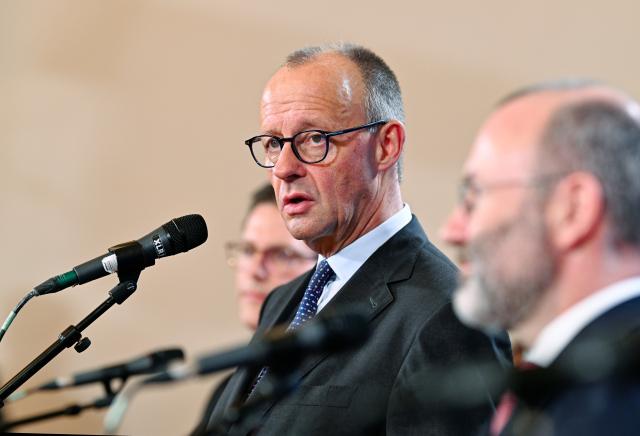 12 December 2025, Baden-Württemberg, Heidelberg: German Chancellor Friedrich Merz (C) speaks alongside Manfred Weber (R), party and group leader of the European People's Party, at a press conference at the end of a board meeting of the EPP Group in the European Parliament. Photo: Uwe Anspach/dpa