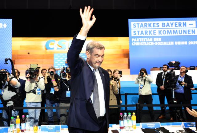 12 December 2025, Bavaria, Munich: Christian Social Union in Bavaria (CSU) Chairman and Minister President of Bavaria Markus Soeder waves upon his arrival to attend the CSU party conference in the exhibition hall. Photo: Karl-Josef Hildenbrand/dpa