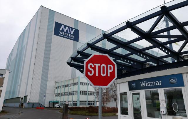 FILED - 31 January 2023, Mecklenburg-Western Pomerania, Wismar: The access road to the former MV shipyard, with the shipbuilding hall in the background. Meyer Werft, the German shipbuilder rescued by the state a year ago, is set to receive a major new order from Swiss cruise operator MSC Cruises, people familiar with the matter told dpa on Friday. Photo: Bernd Wüstneck/dpa