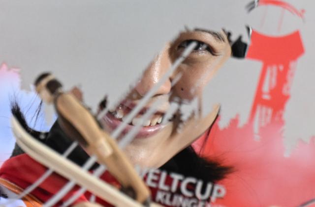 12 December 2025, Saxony, Klingenthal: Japanese ski jumper Nozomi Maruyama looks through her trophy at the award ceremony after the women's large hill 2nd round of the FIS Ski Jumping World Cup in Klingenthal. Photo: Hendrik Schmidt/dpa