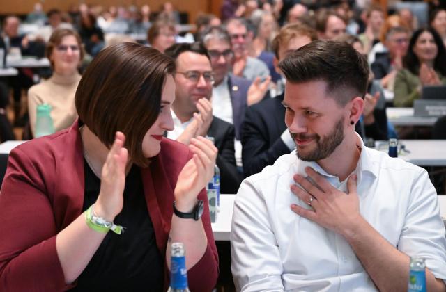 12 December 2025, Baden-Wuerttemberg, Ludwigsburg: Lena Schwelling (L) and Pascal Haggenmueller, the re-elected state executive committee members of the Alliance 90/The Greens (Bündnis 90/Die Grünen) Baden-Wuerttemberg party, 
sit in the front row at the state party conference after the election. Photo: Bernd Weißbrod/dpa