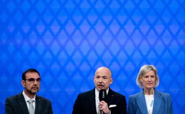 13 December 2025, Bavaria, Munich: Klaus Holetschek, Chairman of the CSU parliamentary group in the Bavarian state parliament, Alexander Hoffmann, Chairman of the CSU in the Bundestag, and Angelika Niebler, Chairwoman of the CSU European Group, on stage at the CSU party conference in the exhibition hall. Photo: Sven Hoppe/dpa