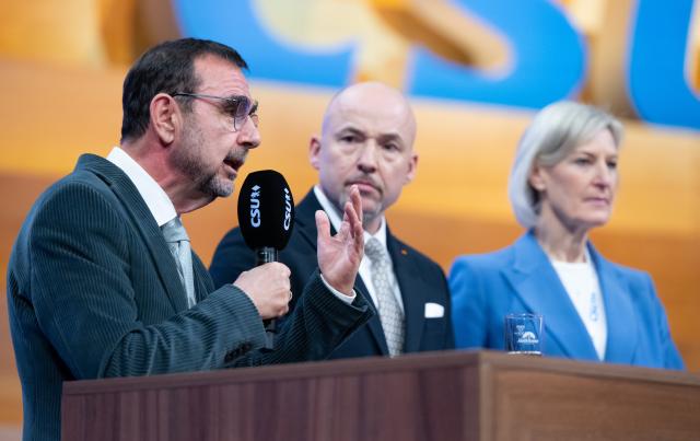 13 December 2025, Bavaria, Munich: Klaus Holetschek, Chairman of the CSU parliamentary group in the Bavarian state parliament, Alexander Hoffmann, Chairman of the CSU in the Bundestag, and Angelika Niebler, Chairwoman of the CSU European Group, on stage at the CSU party conference in the exhibition hall. Photo: Sven Hoppe/dpa