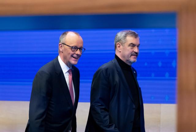 13 December 2025, Bavaria, Munich: Markus Soeder (r), CSU Chairman and Minister President of Bavaria, and German Chancellor Friedrich Merz (CDU) take to the stage at the CSU party conference in the exhibition hall. Photo: Sven Hoppe/dpa