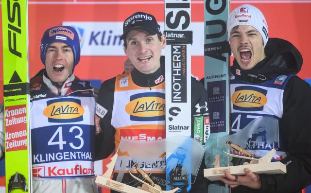 13 December 2025, Saxony, Klingenthal: (L-R) Austria's second placed Stefan Kraft, 
Slovenia's winner Domen Prevc and Germany's third placed Philipp Raimund celebrate at the award ceremony after the men's large hill 2nd round of the FIS Ski Jumping World Cup in Klingenthal. Photo: Hendrik Schmidt/dpa