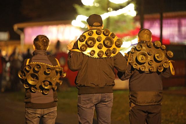 13 December 2025, Saxony-Anhalt, Altenbrak: Three members of the Weihnachtsmaenner e.V. traditional group ringing bells at the Christmas market in Altenbrak. Photo: Matthias Bein/dpa