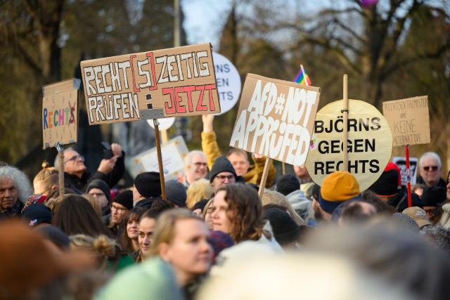 13 December 2025, Hamburg: People stand in front of the stage during the second "PRUeF" demonstration to demand the Federal Constitutional Court to investigate all parties classified as suspected cases by the Office for the Protection of the Constitution. Photo: Gregor Fischer/dpa