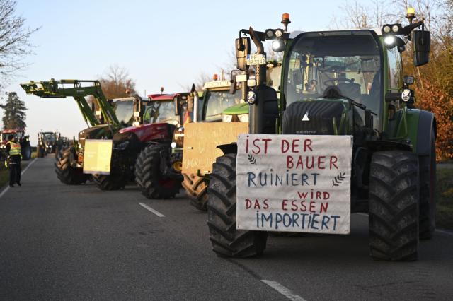 15 December 2025, Baden-Wuerttemberg, Bad Wimpfen: Farmers gather with their tractors outside Lidl's headquarters as part of a nationwide protest against persistently low milk and butter prices, calling for fairer returns for agricultural producers. Photo: Katharina Kausche/dpa