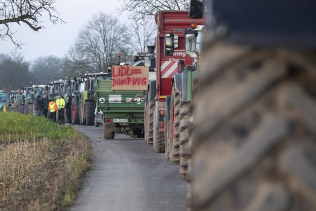 15 December 2025, Baden-Wuerttemberg, Bad Wimpfen: Farmers gather with their tractors outside Lidl's headquarters as part of a nationwide protest against persistently low milk and butter prices, calling for fairer returns for agricultural producers. Photo: Marijan Murat/dpa