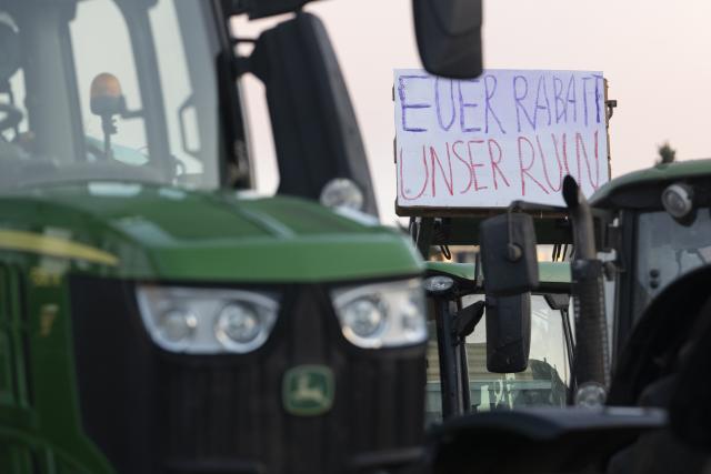 15 December 2025, Baden-Wuerttemberg, Bad Wimpfen: Farmers gather with their tractors outside Lidl's headquarters as part of a nationwide protest against persistently low milk and butter prices, calling for fairer returns for agricultural producers. Photo: Marijan Murat/dpa