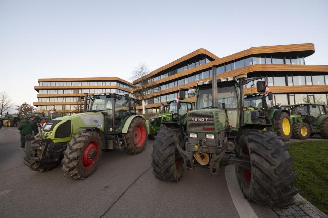 15 December 2025, Baden-Wuerttemberg, Bad Wimpfen: Farmers gather with their tractors outside Lidl's headquarters as part of a nationwide protest against persistently low milk and butter prices, calling for fairer returns for agricultural producers. Photo: Marijan Murat/dpa