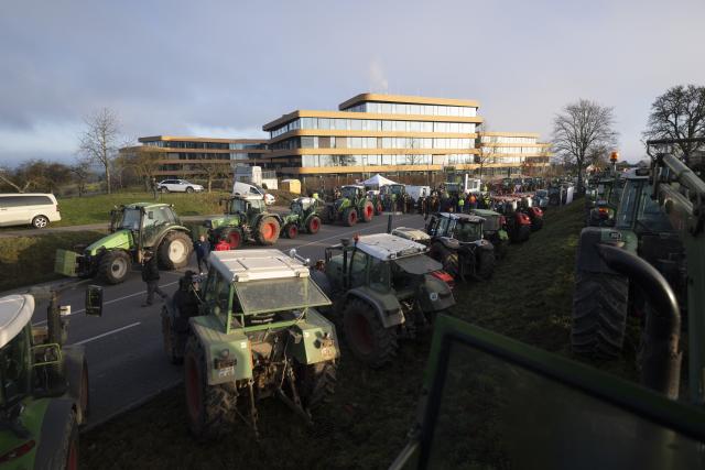 15 December 2025, Baden-Wuerttemberg, Bad Wimpfen: Farmers gather with their tractors outside Lidl's headquarters as part of a nationwide protest against persistently low milk and butter prices, calling for fairer returns for agricultural producers. Photo: Marijan Murat/dpa