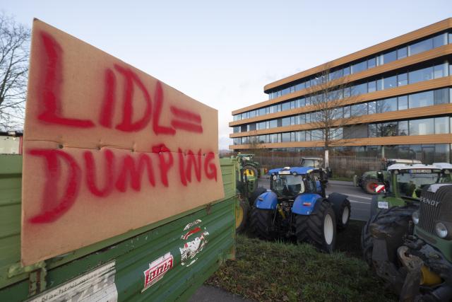 15 December 2025, Baden-Wuerttemberg, Bad Wimpfen: Farmers gather with their tractors outside Lidl's headquarters as part of a nationwide protest against persistently low milk and butter prices, calling for fairer returns for agricultural producers. Photo: Marijan Murat/dpa