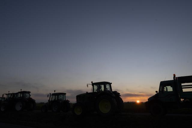 15 December 2025, Baden-Wuerttemberg, Bad Wimpfen: Farmers gather with their tractors outside Lidl's headquarters as part of a nationwide protest against persistently low milk and butter prices, calling for fairer returns for agricultural producers. Photo: Marijan Murat/dpa