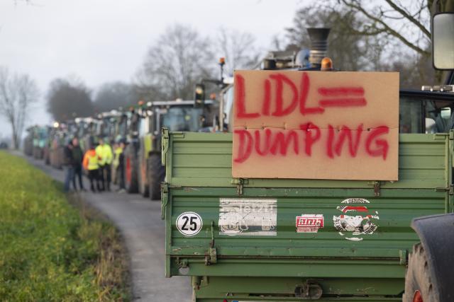 15 December 2025, Baden-Wuerttemberg, Bad Wimpfen: Farmers gather with their tractors outside Lidl's headquarters as part of a nationwide protest against persistently low milk and butter prices, calling for fairer returns for agricultural producers. Photo: Marijan Murat/dpa