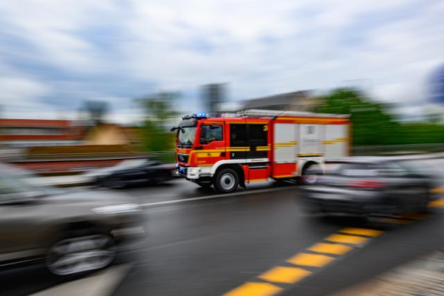 FILED - 15 April 2024, Saxony, Dresden: A fire engine drives to an operation with blue lights flashing. Authorities lift tram after girl trapped between train and platform Photo: Robert Michael/dpa
