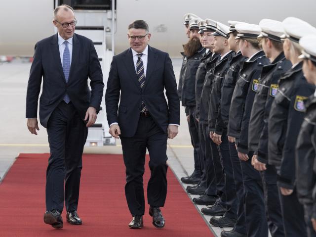 16 December 2025, Hesse, Frankfurt/Main: Boris Rhein (R), receives German Chancellor Friedrich Merz (CDU) at Frankfurt Airport. Photo: Boris Roessler/dpa