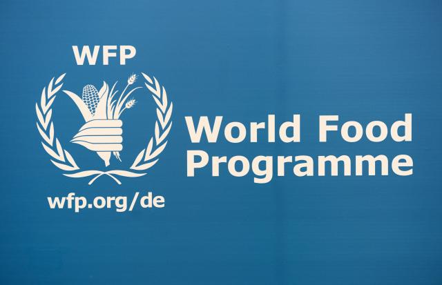 FILED - 14 March 2013, Saxony, Leipzig: The logo of the World Food Programme (WFP) is on display at the book fair in Leipzig. Photo: Jens Kalaene/dpa-Zentralbild/dpa