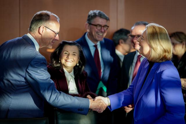17 December 2025, Berlin: German Chancellor Friedrich Merz (L) shakes hands with Baerbel Bas, German Minister of Labor and Social Affairs and Social Democratic Pary (SPD) party chairwoman ahead of the German Cabinet meeting at the German Chancellery in Berlin. Photo: Kay Nietfeld/dpa