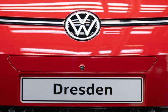 18 December 2025, Saxony, Dresden: A red ID.3 with the lettering "Dresden" stands in the light tunnel on the production line of Volkswagen's Transparent Factory, which has already been shut down. The vehicle was the last car to roll off the production line on December 16, 2025 and was signed by all employees. Photo: Sebastian Kahnert/dpa