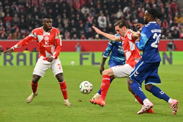 18 December 2025, Rhineland-Palatinate, Mainz: Mainz's Dominik Kohr and Samsunspor's Antoine Makoumbou (R) battle for the ball during the UEFA Europa Conference League soccer match between FSV Mainz 05 and Samsunspor at the Mewa Arena. Photo: Torsten Silz/dpa