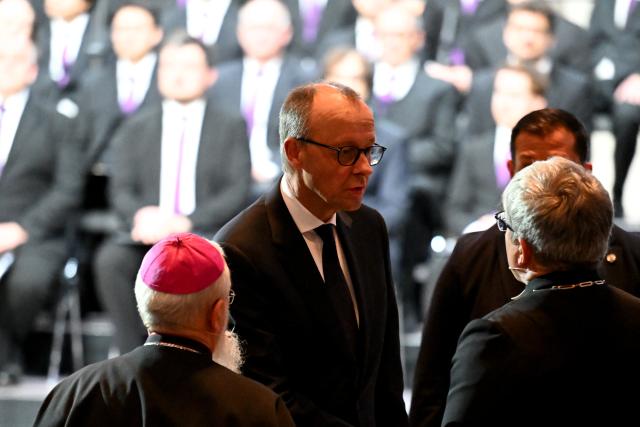 20 December 2025, Saxony-Anhalt, Magdeburg: Germany's Chancellor Friedrich Merz (2nd L) welcomes Bishop Gerhard Feige (L) and Bishop Friedrich Kramer to St. John's Church for a memorial service marking one year since the attack on Magdeburg's Christmas market. On 20 December 2024, a man drove a car into a crowd, killing five women and a child and injuring more than 300 people. Photo: Hendrik Schmidt/dpa