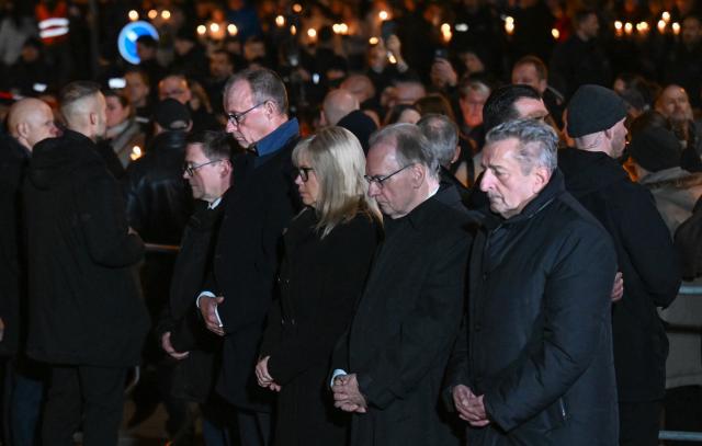 20 December 2025, Saxony-Anhalt, Magdeburg: R-L) Gunnar Schellenberger, President of the State Parliament of Saxony-Anhalt, Reiner Haseloff, Minister President of Saxony-Anhalt, Simone Borris, Mayor of Magdeburg, and German Chancellor Friedrich Merz take part in a memorial service at St. John's Church in Magdeburg one year after the attack on the Magdeburg Christmas market. On 20 December 2024, a man drove a car into a crowd, killing five women and a child and injuring more than 300 people. Photo: Hendrik Schmidt/dpa