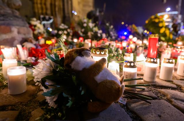 20 December 2025, Saxony-Anhalt, Magdeburg: Countless candles and flowers are seen in front of St. John's Church in Magdeburg one year after the attack on the Magdeburg Christmas market, following a memorial service held inside the church. On 20 December 2024, a man drove a rental car into a crowd at the Christmas market, killing a nine-year-old boy and five women and injuring more than 300 people. Photo: Hendrik Schmidt/dpa