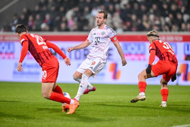 21 December 2025, Baden-Wuerttemberg, Heidenheim: Bayern Munich's Harry Kane (C) battles for the ball with Heidenheim's Luca Kerber (L) and Niklas Dorsch during the German Bundesliga soccer match between 1. FC Heidenheim and Bayern Munich at Voith-Arena. Photo: Harry Langer/dpa - WICHTIGER HINWEIS: Gemäß den Vorgaben der DFL Deutsche Fußball Liga bzw. des DFB Deutscher Fußball-Bund ist es untersagt, in dem Stadion und/oder vom Spiel angefertigte Fotoaufnahmen in Form von Sequenzbildern und/oder videoähnlichen Fotostrecken zu verwerten bzw. verwerten zu lassen.