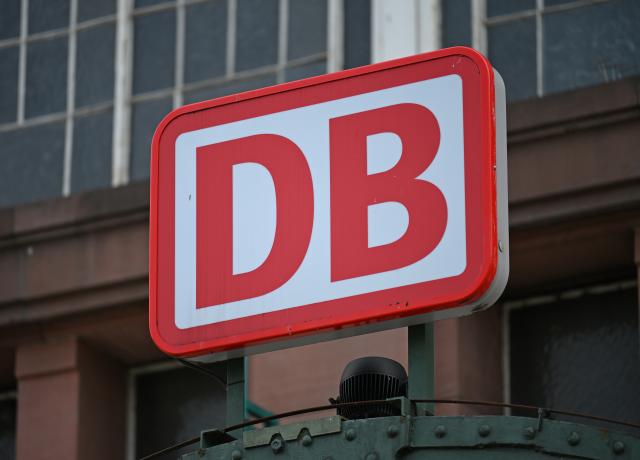 FILED - 19 September 2025, Hesse, Wiesbaden: A Deutsche Bahn logo with the inscription DB hangs above the entrance to the main station. Photo: Michael Brandt/dpa