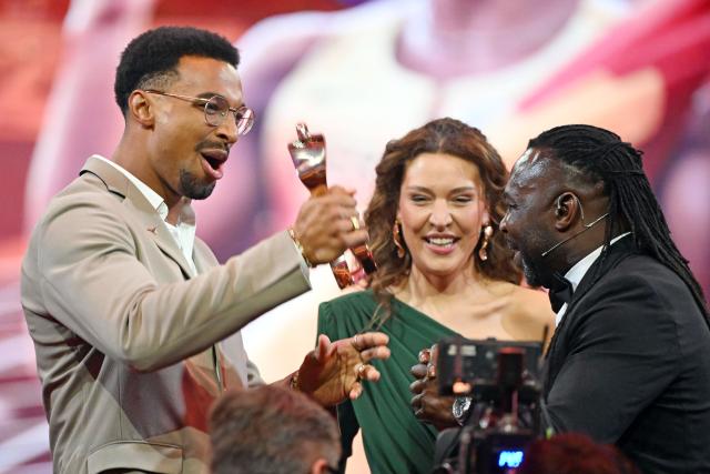 21 December 2025, Baden-Wuerttemberg, Baden-Baden: German decathlete Leo Neugebauer (L) is honored by his father as Sportsman of the Year 2025 during the Sportsman of the Year 2025 gala at the Kurhaus Baden-Baden. Photo: Uli Deck/dpa