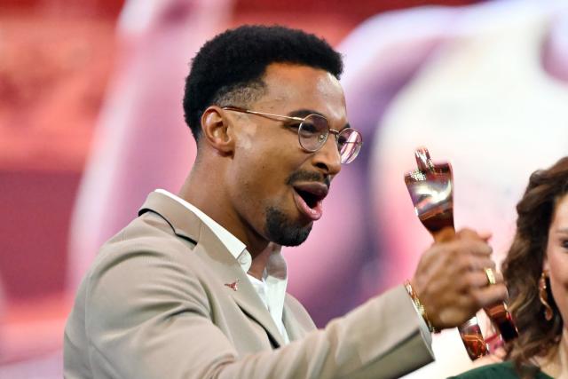21 December 2025, Baden-Wuerttemberg, Baden-Baden: German decathlete Leo Neugebauer celebrates the trophy of the Sportsman of the Year 2025 during the Sportsman of the Year 2025 gala at the Kurhaus Baden-Baden. Photo: Uli Deck/dpa