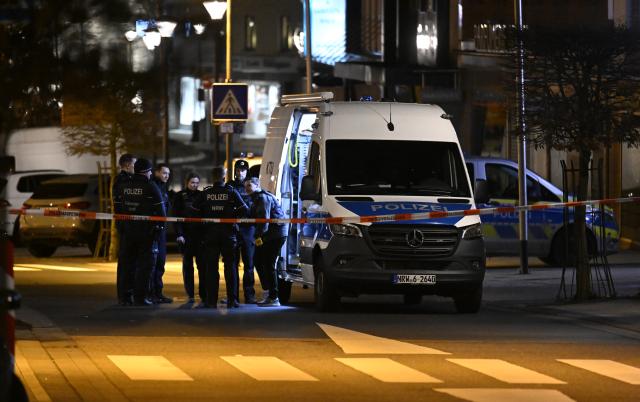 21 December 2025, North Rhine-Westphalia, Geilenkirchen: Police officers stand at the scene in the city center of Geilenkirchen, where shots were fired. A man was shot and injured. Photo: Roberto Pfeil/dpa