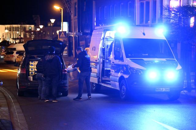 21 December 2025, North Rhine-Westphalia, Geilenkirchen: Police officers stand at the scene in the city center of Geilenkirchen, where shots were fired. A man was shot and injured. Photo: Roberto Pfeil/dpa